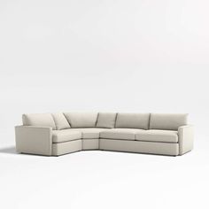 a white sectional couch sitting on top of a white floor