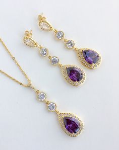 I've created these absolutely gorgeous super sparkly long purple amethyst crystal earrings in gold plated brass setting. Earrings feature a large teardrop with pear cut purple amethyst cubic zirconia center surrounded by tiny round zirconia crystals. Teardrop dangles from a bright cubic zirconia ear stud and two round cubic zirconia connectors. Total length of the earrings is 6 cms. For matching necklace click: For matching bracelet click: To browse my collection click : https://www.etsy.com/sho Purple Dangle Bridal Earrings For Formal Occasions, Elegant Purple Long Drop Jewelry, Elegant Long Drop Purple Jewelry, Amethyst Jewelry With Matching Earrings For Wedding, Wedding Amethyst Jewelry Set With Matching Earrings, Purple Amethyst Earrings For Wedding, Wedding Amethyst Jewelry With Matching Earrings, Purple Dangle Bridal Earrings, Purple Crystal Earrings For Wedding