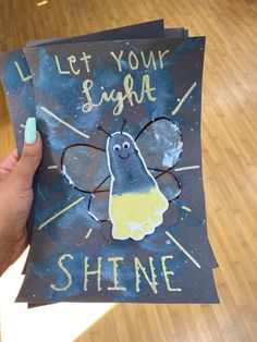 someone holding up a card that says let your name shine