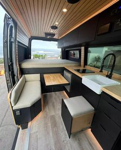 the inside of a camper with two couches and a kitchenette in it