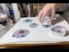 a person is making something out of paper on a table