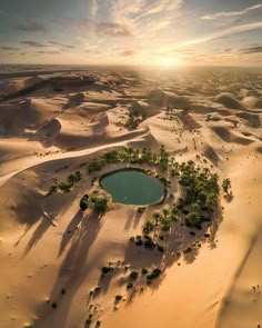 an aerial view of a small lake surrounded by sand dunes