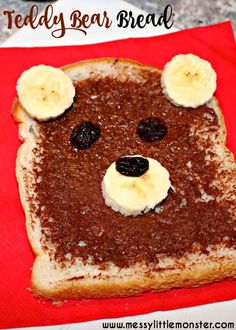 a toasted bread with fruit on it and a face made to look like a bear