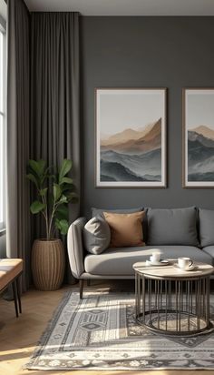 a living room with two paintings on the wall and a coffee table in front of it