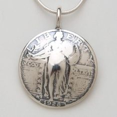 Pendant made from a vintage silver American Standing Liberty quarter coin.  There is an eagle on the reverse side.  I do not have a picture of it at this time.  It comes on a sterling silver bead chain, not the snake chain pictured.  Please select your preferred length.  To make one of these pieces, the face is sanded off on one side of a coin (except for those pieces with the coin image on both sides). Then using traditional hammering and forging techniques, the shape is formed, the designs are Heart Locket Necklace, Rosé Heart, Lady Liberty, An Eagle, The Snake, Bead Chain, Coin Jewelry, Silver Bead, Heart Locket