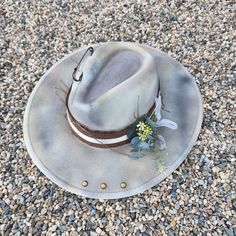 "The Gravel is all things beautiful! The colors in this hat look natural and calming... definitely a must have!  Handmade Fedora hats with Western style bling. All hats are ONE OF A KIND and designed personally by myself. Purposely aged to add lots of character! I enjoy creating unique items for others to enjoy in this mass produced world. Be UNIQUE... stand out in the crowd!  All hats are made to fit differently- this hat is considered a (M/L) measuring approx. 23.5\" with a tie to make adjustm Rustic Adjustable Felt Hat For Kentucky Derby, Rustic Fedora Hat For Kentucky Derby, Rustic Wide Brim Hat For Kentucky Derby, Rustic Fedora Hat, One Size Fits Most, Rustic Fedora Hat One Size, Handmade Country Hat For Outdoor, Rustic Brimmed Fedora One Size Fits Most, Rustic Curved Brim Hat For Kentucky Derby, Rustic Brimmed Fedora (one Size Fits Most)