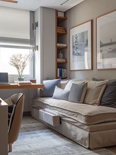 a living room filled with furniture next to a desk and window covered in bookshelves