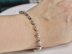 This bracelet is made with sterling silver 925 that has been rhodium plated so it doesn't tarnish or change color. Bracelet is made with figaro chain that is 18 cm plus 1.5 cm extension/ 7.1 inch pus 0.5 inch extension long . Bracelet has 12 beads ( 10 Hail Mary and 2 x Our Father beads ) and each bead is diamond cut. Bead size is : - small 5 mm beads - medium 6 mm beads - large 7 mm beads On the end of bracelet we have placed small crucifix that dangles. Each product is possible to have blessed Silver Dainty Rosary Bracelet With Round Beads, Silver Rosary Bracelet With Silver Beads, Dainty Silver Rosary Bracelet With Round Beads, Adjustable Silver Rosary Bracelet, Elegant Sterling Silver Rosary In Silver, Silver Hypoallergenic Rosary Bracelet, Elegant Silver Sterling Silver Rosary, Cheap Adjustable Nickel-free Rosary Bracelet, Nickel-free Silver Rosary Bracelet For Spiritual Use