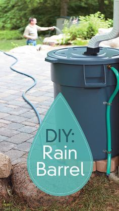 a blue rain barrel sitting on top of a brick patio next to a green hose