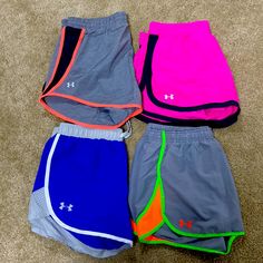 three shorts laying on the floor next to each other with different colors and designs in them