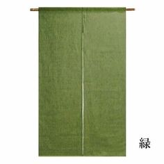 a green curtain hanging on the side of a wall