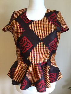 Formal Peplum with tail Back Elegant Blouse in African Prints   Can be customised in colour, sizes, African prints Fitted Sleeveless Printed Blouse, Multicolor Batik Print Short Sleeve Top, Multicolor Short Sleeve Tops With Batik Print, Fitted Yellow Printed Tops, Fitted Patterned Short Sleeve Tops, Patterned Fitted Short Sleeve Tops, Fitted Patterned Top With Short Sleeves, Fitted Multicolor Tops With Bold Print, Fitted Multicolor Top With Bold Print