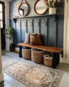 a bench with baskets and mirrors on the wall