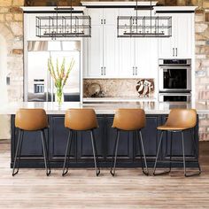 three brown chairs are sitting in front of the kitchen island with four barstools