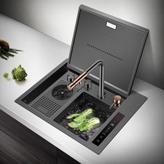 a stove top with some vegetables on the counter and an appliance attached to it