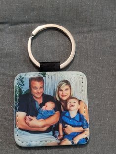 a key chain with an image of a family on it