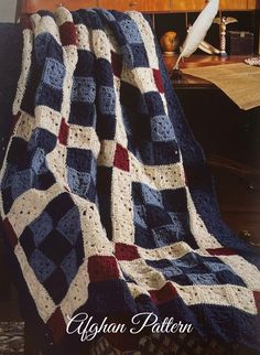 a crocheted afghan is sitting on a chair