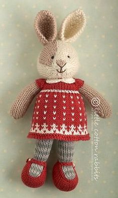 a knitted bunny doll with red dress and boots