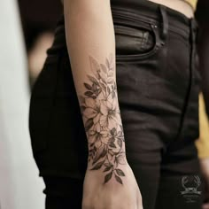 a woman with a flower tattoo on her arm