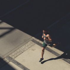 a man is running down the street with words that read run for a hotter hour