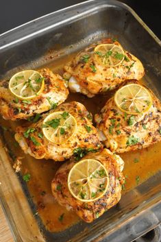 chicken with lemons and herbs in a pan