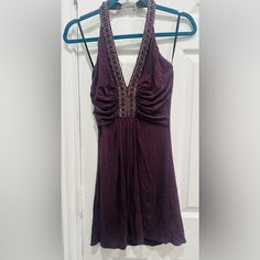 This Nwot, Sky Dress Is A Size Medium. The Color Is A Deep Plum. Accent Ruching Around Bust Line. Embellished With Purple Jewels And Pearls, That Creates A Low V Neck And Wraps All The Way Around The Neck Line. Adjustable Clasp Closure. Backless Approximate Measurements: Pit To Pit 13”, Length 29”. Never Been Worn, Stunningly Sexy Dress! Embellished V-neck Dress For Date Night, Halter Neck Embellished Mini Dress For Cocktail, Embellished Halter Neck Cocktail Mini Dress, Cocktail Halter Neck Embellished Mini Dress, Chic Embellished Halter Neck Dress, Embellished Halter Neck Cocktail Dress, Embellished Fitted Halter Dress For Cocktail, Embellished Halter Neck Mini Dress For Date Night, Embellished V-neck Mini Dress For Date Night