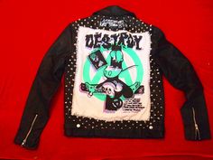 "Part of the Femin x Addicted to Chaos collaboration. Repurposed \"Forever 21\" black faux leather vegan moto jacket, size small. Fully patched and fully studded by hand, using patches created by Addicted to Chaos.  Features a huge 2 colored silk screened \"Destroy\" crucified Mickey back patch.  Patches on the front are: Addicted to Chaos, and \"NO FUTURE\".  Hand crafted by Femin using Addicted to Chaos patches and repurposed materials." Spring Punk Style Biker Jacket For Alternative Fashion, Edgy Fitted Outerwear With Graphic Print, Spring Punk Biker Jacket For Alternative Fashion, Fitted Edgy Outerwear With Graphic Print, Edgy Leather Jacket With Graphic Print For Winter, Fall Graphic Print Biker Jacket For Biker Events, Graphic Print Biker Jacket For Fall Events, Fall Biker Jacket With Graphic Print For Biker Events, Edgy Graphic Print Biker Jacket For Biker Events