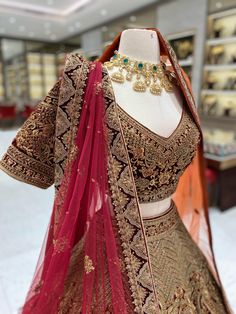 Feel like royalty on your special day with our Burgundy Gold Bridal Lehenga. The rich burgundy color is complemented by intricate gold bead work on the velvet blouse. The velvet border adds a touch of elegance to this beautiful lehenga. Stand out and make a statement with this luxurious piece. Fabric: Net with Raw Silk lining! WASH CARE INSTRUCTIONS - Please Dry clean only when it is applicable! Ready to Ship! Burgundy Lehenga, Bridal Lehenga Maroon, Red Lehenga With Gold Embroidery For Wedding, Gold Lehenga With Red Dupatta, Maroon And Golden Lehenga, Gold Lehenga, Green Street, Velvet Blouses, Bridal Stores