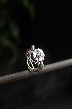 ITEM DESCRIPTION: The size of ring 7 (US and Canada) O (UK and AU) I can make it any size you want - just mark your size in the order Weight - 2,5 g. I made this botanical ring of sterling silver and garnet. I placed a highly detailed poppy flower in the center. And the leaves are located on the sides of it. I can make it with different gemstones - write to me and will discuss your custom order. I usually respond to letters very quickly. This Elven ring will be a great addition to your jewelry c Adjustable Flower Crystal Ring, Flower Shaped Birthstone Promise Ring, Nature-inspired Flower Wedding Rings, Metal Flower Ring For Promise, Flower Shaped Metal Ring For Promise, Nature-inspired Round Flower Ring For Anniversary, Heirloom Flower Ring Gift, Heirloom Flower Ring For A Gift, Nature-inspired Flower Promise Ring