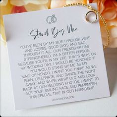 a card that says stand by me with two wedding rings on it next to flowers