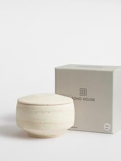 a white bowl sitting next to a box