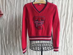 Collectible Tommy Hilfiger sweater from the 90s Size Petite Small 100 percent cotton   Huge Chenille Patch Applique Striped ribbing Traditional Red, White, Blue   Measurements taken laid flat side to side: (so double) Shoulder to Shoulder seam:  15 inches Under arm to under arm: 15 inches Waist 14 inches Length from neckline to hemline is 20 inches Sleeve measures 24.5 from shoulder to wrist 90s Style Cotton Sweater, 90s Style Sweater For College In Winter, 90s Style Long Sleeve Cotton Sweater, 90s Style Winter Sweater For College, 90s Style College Sweater For Winter, 90s Style Cotton Sweater For Fall, Tommy Hilfiger V Neck Sweater, Patch Applique, Chenille Patch