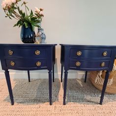 two blue nightstands side by side on carpeted floor next to vase with flowers