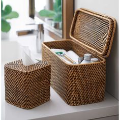 two wicker baskets sitting on top of a counter