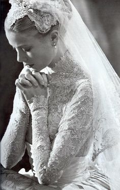 a black and white photo of a woman in a wedding dress with her hands on her face