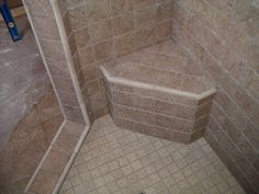 a shower stall with tiled walls and floor