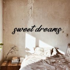 a bedroom with the words sweet dreams written on the wall next to it and a bed