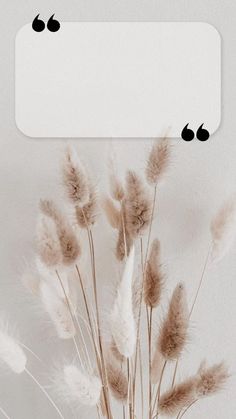 a vase filled with lots of brown and white flowers next to a sign that says love