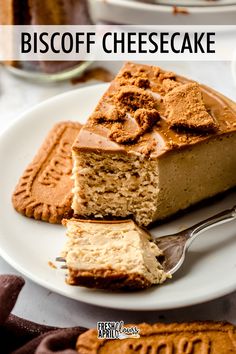 a piece of cheesecake on a white plate with a fork next to it and the words biscoff cheesecake