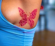 a woman with a butterfly tattoo on her chest