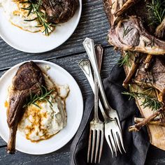 two white plates topped with steak and mashed potatoes on top of a wooden table