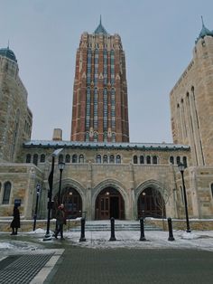 two tall buildings sitting next to each other on top of a snow covered ground in front of a blue sky