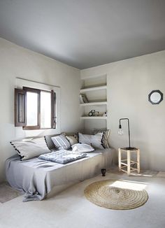 a bedroom with a bed and shelves in it