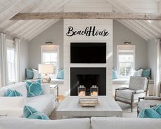 a living room filled with furniture and a flat screen tv mounted on the wall above a fireplace