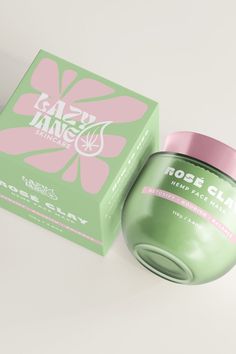 a green box with a pink lid next to it