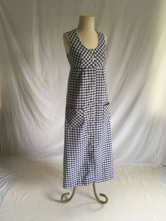 "vintage 1970s maxi dress Barclay Square blue and white gingham button up front scoop neck sleeveless high waist 2 front hand pockets unlined feels like cotton blend, w/maybe polyester good vintage condition, light wear labeled size 10, see below measures, lying flat, shoulder-12 3/4\" chest-17 1/2: to 18\" w/breast darts waist seam-15\" hip-20\" top to waist seam-13\" total length-53\"" Vintage Sundress Pattern, Fitted Cotton Maxi Dress For Picnic, Gingham Dress With Buttons For Picnic, Gingham Dresses With Buttons For Picnic, Cotton Buttoned Dress For Picnic, Summer Gingham Dress With Button Closure, Gingham Maxi Dress For Picnic, Cotton Dresses With Buttons For Picnic, Sleeveless Gingham Dress With Buttons