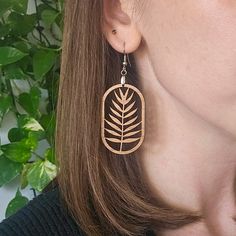 Add a touch of nature-inspired beauty to your look with a pair of botanical fern leaf dangle earrings. 🌿 Our collection of plant-themed jewelry is perfect for plant lovers and a great gift idea for a plant lady or plant mom in your life. The intricate leaf design is cut from eco-friendly cherry wood material and attached to nickel-free, stainless steel hooks. While no metal is considered hypo-allergenic for everyone, stainless steel is often a good choice for people with sensitivities to nickel and other metals.These earrings are big enough to make a statement, yet lightweight enough to be comfortable for all-day wear. See the size information below and in product photos for precise measurements.SIZE INFORMATION 📏Total Earring Drop Length: 2.75" longWood Leaf: 1.75" long x 1" wideYour or Plant Earrings, Wood Dangle Earrings, Jewelry Gift Ideas, Lover Jewelry, Fern Leaf, Unique Plants, Earring Cards, Plant Mom, Themed Jewelry