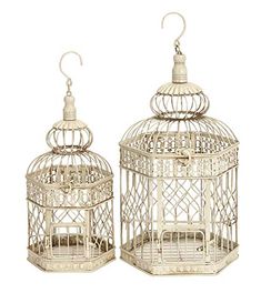 two white bird cages sitting next to each other