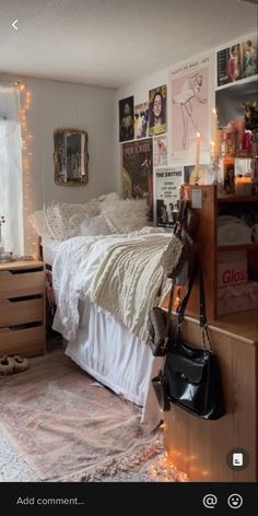 a bed room with a neatly made bed and pictures on the wall