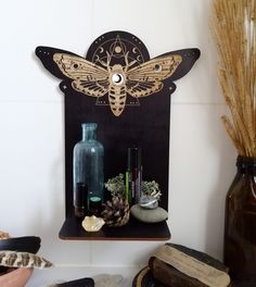 a shelf with some vases and other items on it next to a wall mounted clock